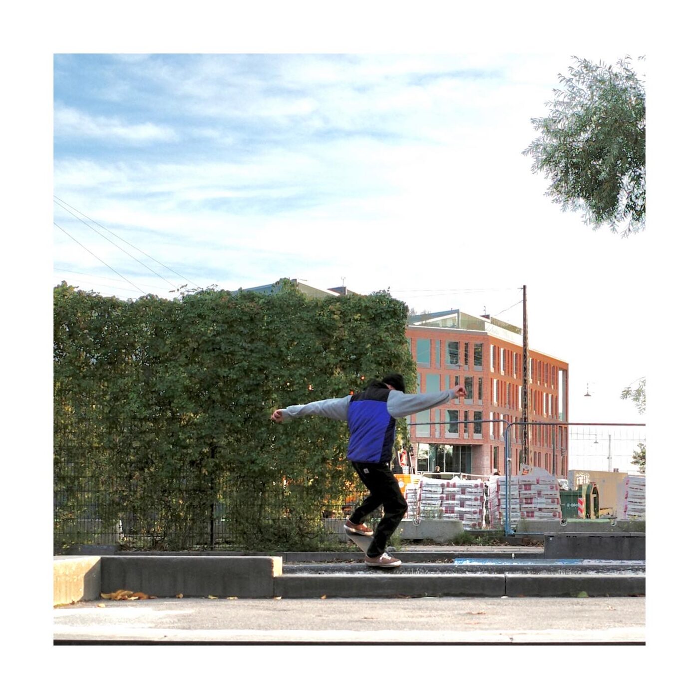 Skateboarder mid-air against a colorful building